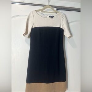 White House Black Market Navy Blue dress with White top and tan trim on the hem